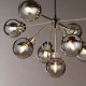 Lampadario moderno grande in acciaio con 9 diffusori a boccia in vetro