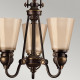 Lampadario rustico con struttura in acciaio e 3 diffusori in vetro ambrato
