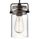 Lampada a sospensione in acciaio con un diffusore in vetro dal design industrial