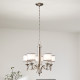 Lampadario rustico in acciaio con diffusori in vetro opalino e maglia di lino