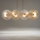 Lampadario moderno con struttura dorata e diffusori in vetro
